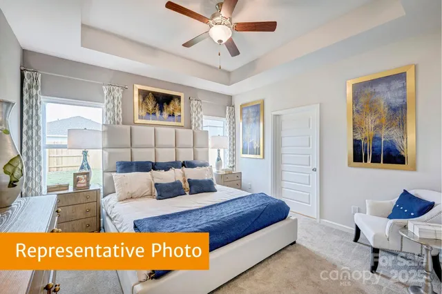 a bed room with a bed and a painting on the wall