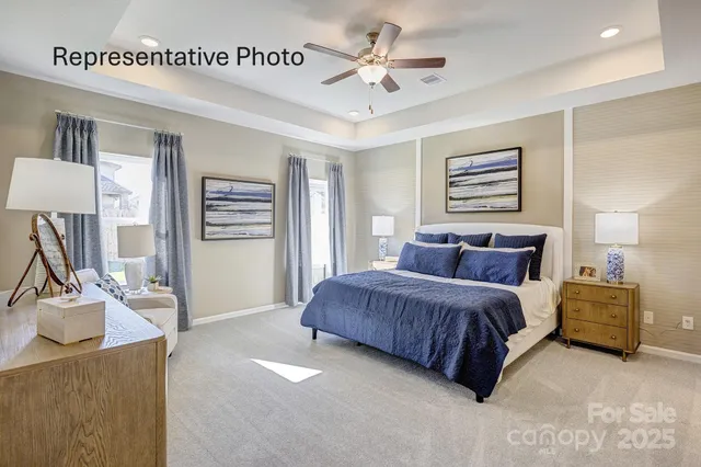 a spacious bedroom with a bed a window and a couch