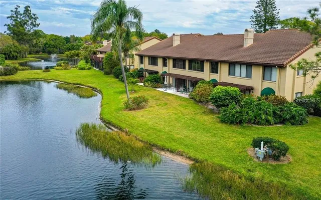 a view of a house with pool and a yard