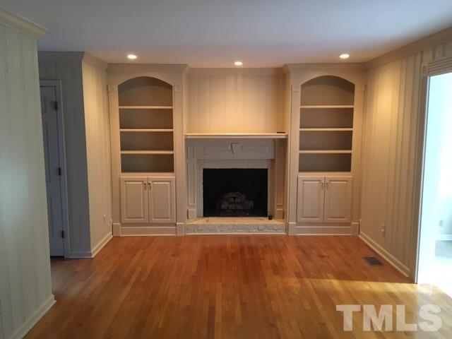 3732 Lassiter Mill Road Raleigh, NC 27609 - Photo 2 of 11 a view of an empty room with a fireplace and a window