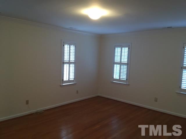 3732 Lassiter Mill Road Raleigh, NC 27609 - Photo 7 of 11 an empty room with wooden floor and windows