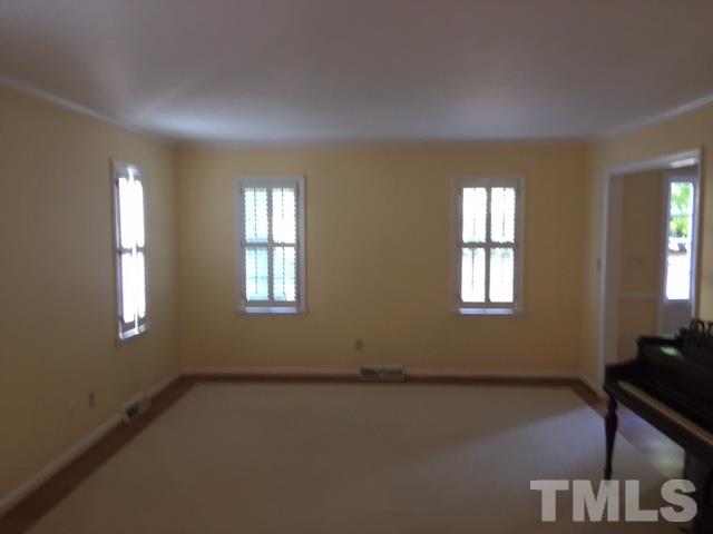 3732 Lassiter Mill Road Raleigh, NC 27609 - Photo 8 of 11 a view of an empty room with a window