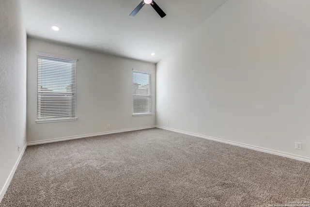 a view of a livingroom with a ceiling fan and window