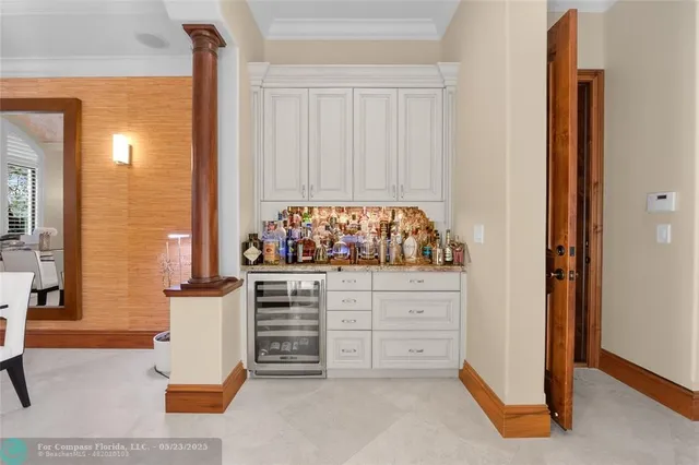 a dining room with furniture a chandelier and wooden floor