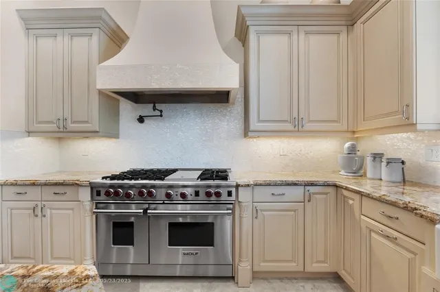 a living room with furniture a fireplace and a large window