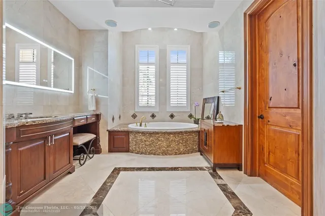 a spacious bedroom with a bed a table and a chandelier
