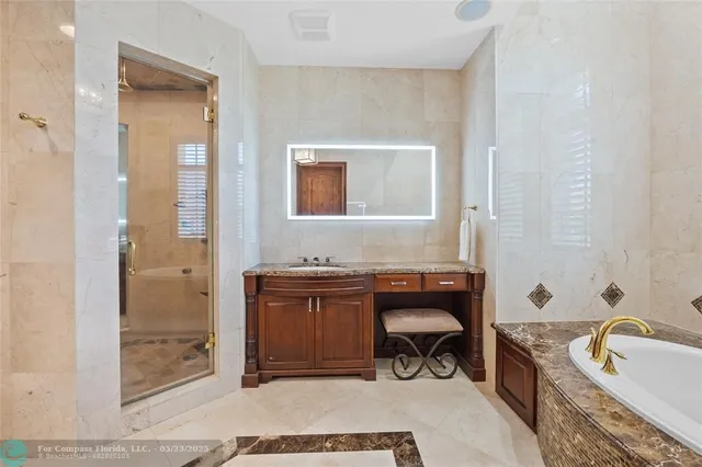 a bathroom with a granite countertop toilet sink and mirror