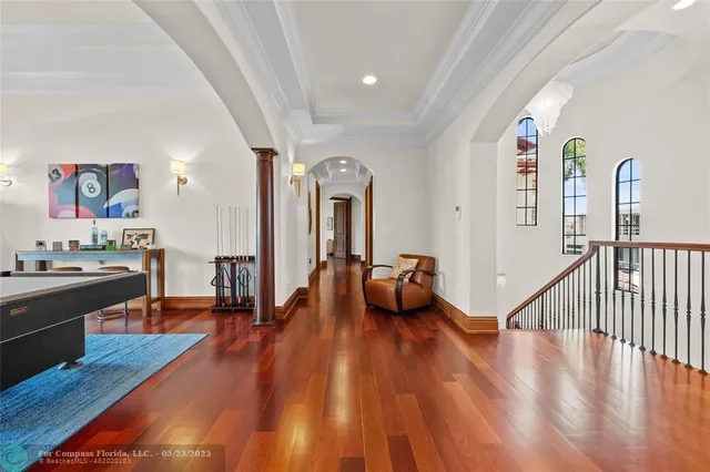 a view of a lake with lawn chairs under an umbrella