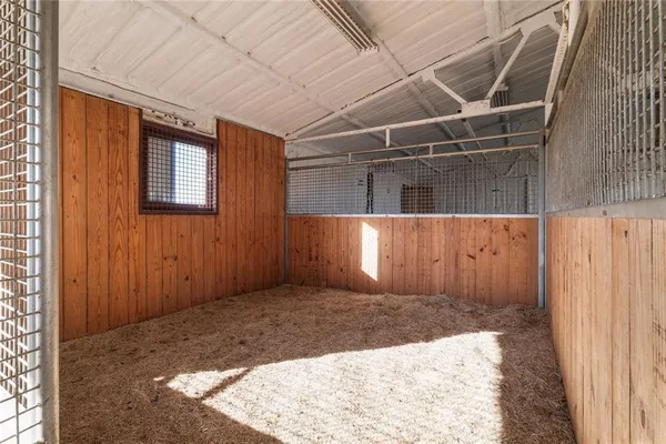 a view of an empty room with a fireplace and a window