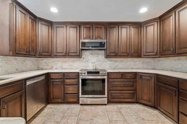 a kitchen with granite countertop white cabinets and a sink