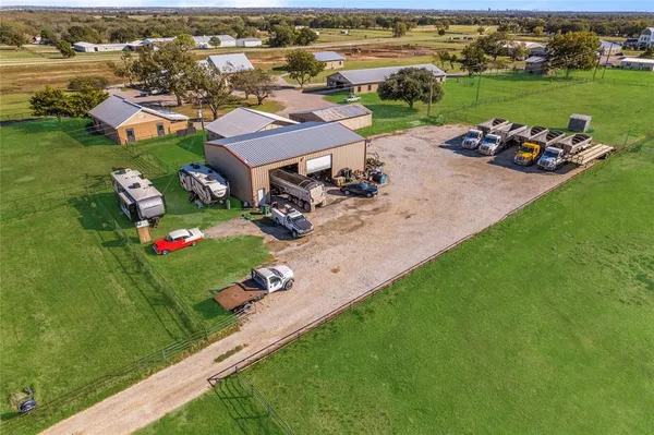 an aerial view of a house with a garden and lake view