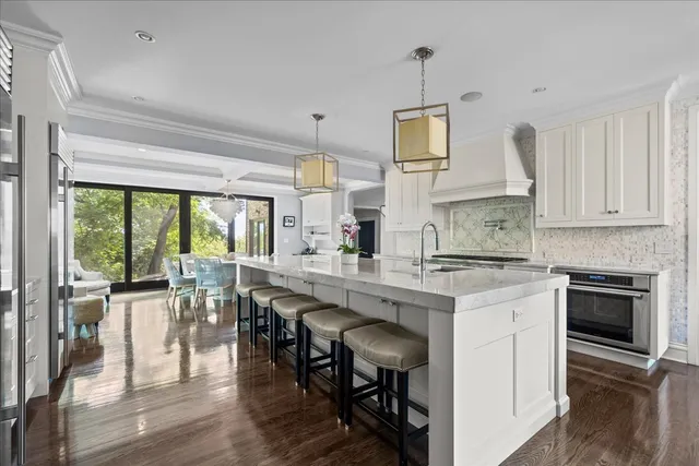 a bedroom with a large bed and a chandelier