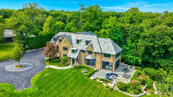 an aerial view of a house with a yard