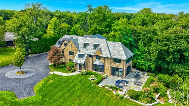 an aerial view of a house with a yard