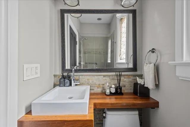 a bathroom with a granite countertop shower and a sink