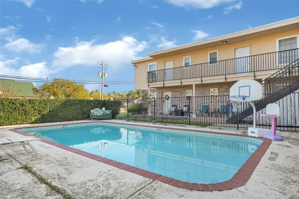 a view of a swimming pool with outdoor seating
