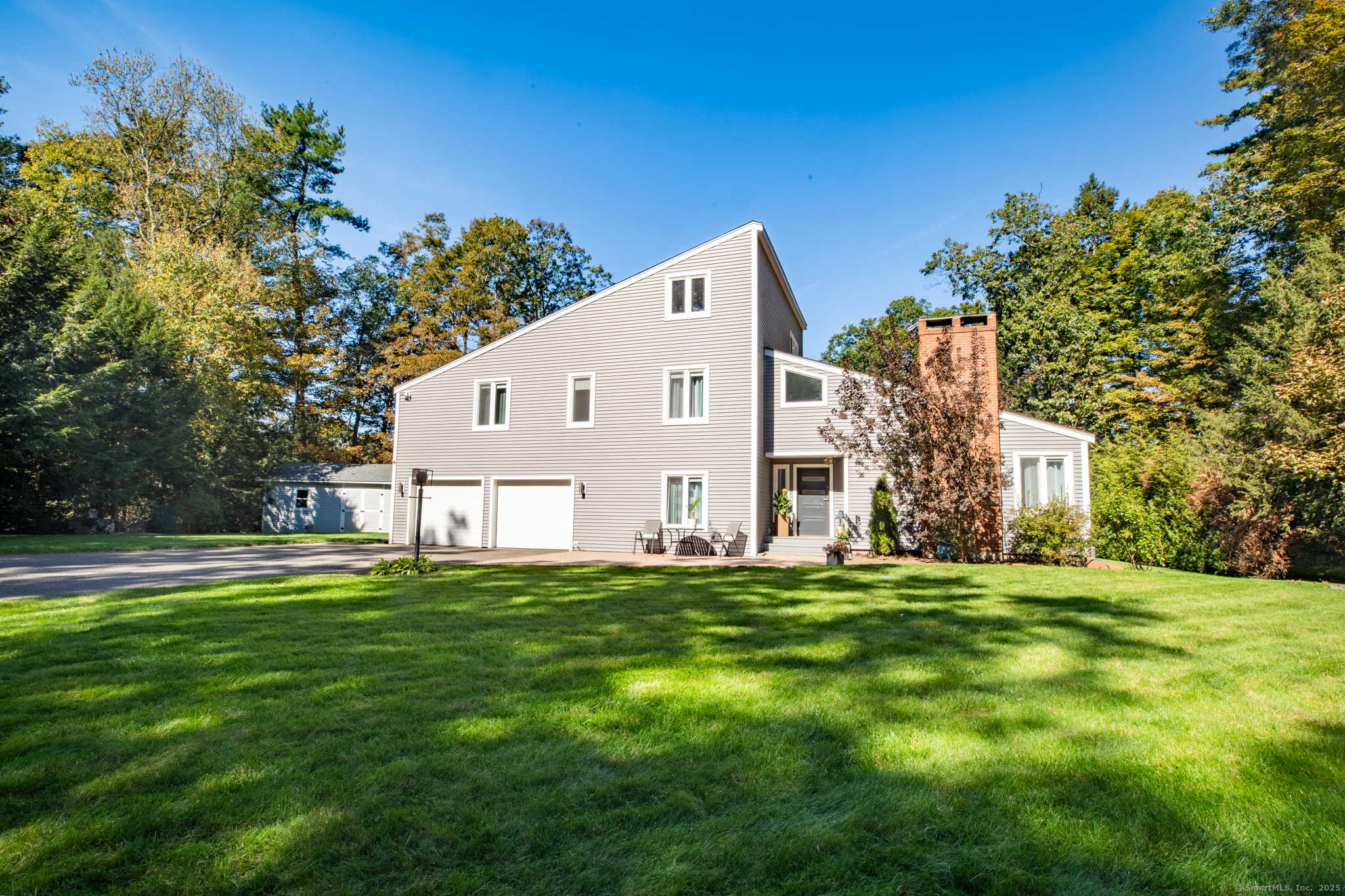 21 High Ridge Drive Granby, CT 06035 - Photo 1 of 1 a view of a white house with a big yard and large trees
