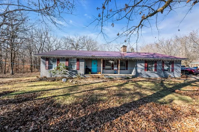 a front view of a house with a yard table and chairs