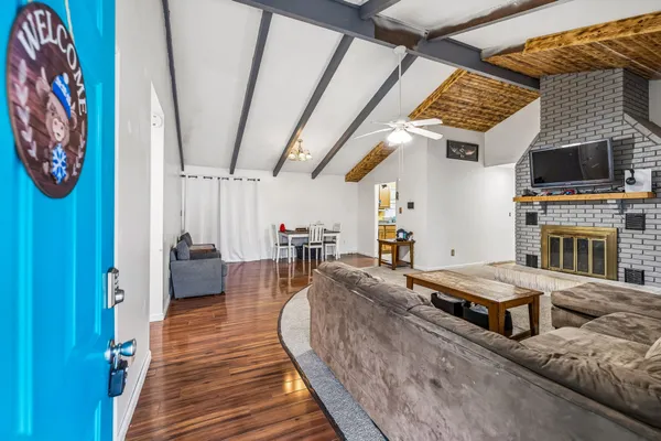 a living room with furniture and a kitchen view