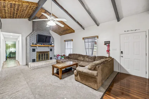 a living room with furniture a couch and a chandelier