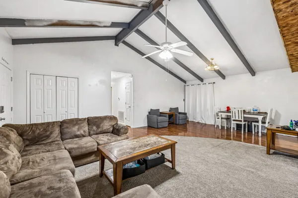 a living room with furniture and a chandelier