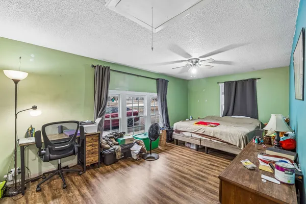 a bedroom with a large bed and a chandelier