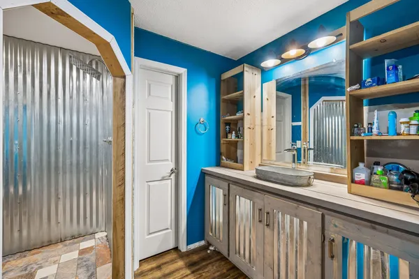 a bathroom with a granite countertop sink a toilet and a mirror
