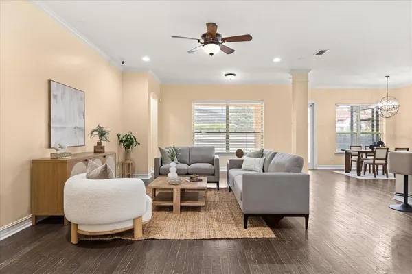 a large kitchen with counter top space a sink stainless steel appliances and cabinets