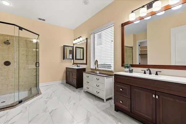 a bathroom with a sink vanity tub and a mirror