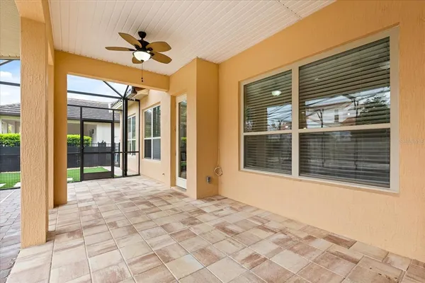 a walk in closet with wooden floor