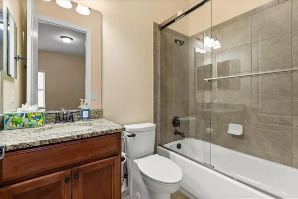 a bathroom with a toilet tub and shower