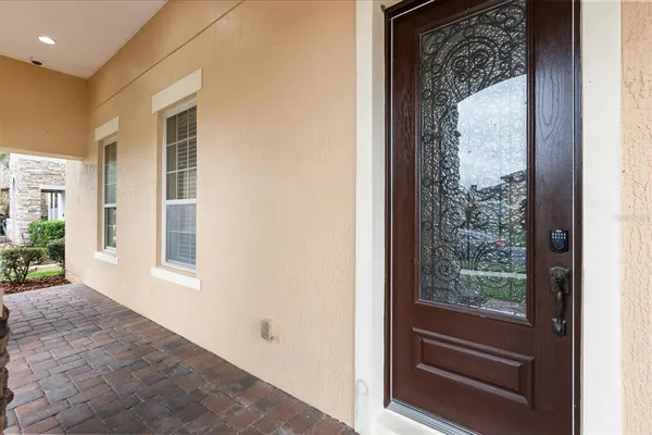a dining room with furniture a chandelier and wooden floor