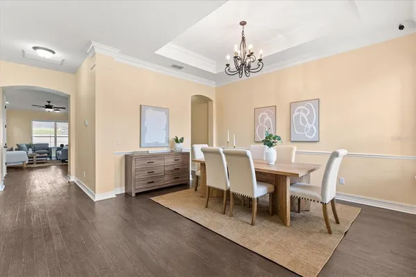 a view of a dining room with furniture wooden floor and chandelier