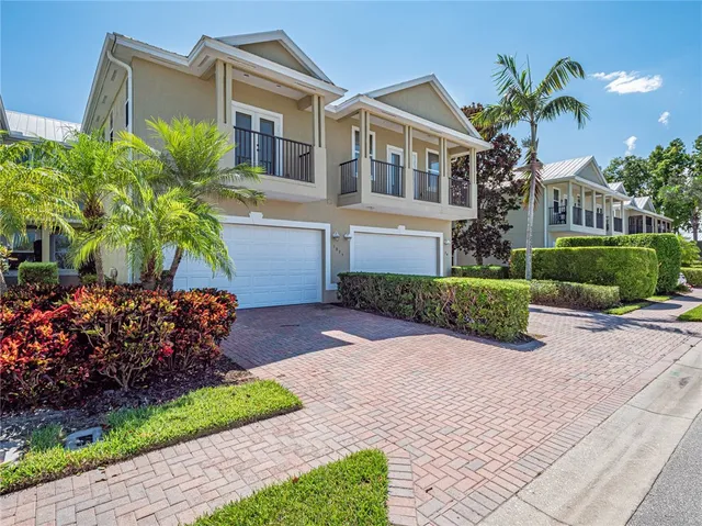 a front view of a house with a yard and potted plants