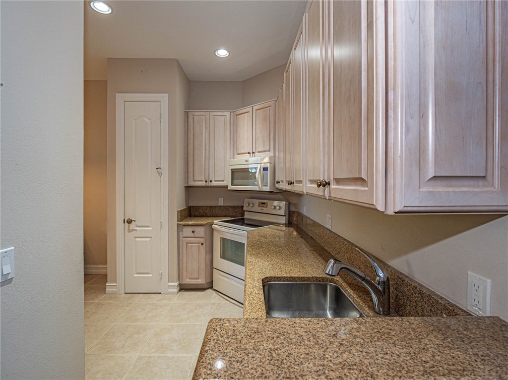 1875 Bridgepointe Circle, Unit 33 Vero Beach, FL 32967 - Photo 12 of 33 a kitchen that has a sink cabinets and stainless steel appliances