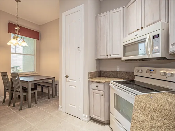 a kitchen with a stove and white cabinets