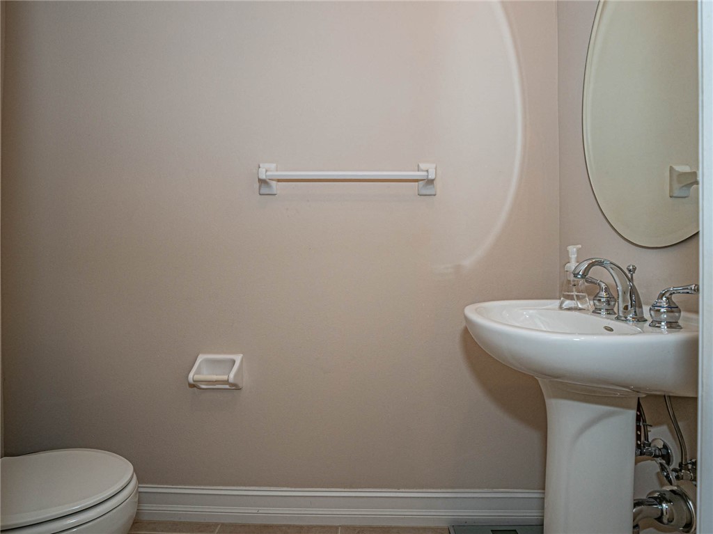 1875 Bridgepointe Circle, Unit 33 Vero Beach, FL 32967 - Photo 16 of 33 a bathroom with a sink mirror and toilet