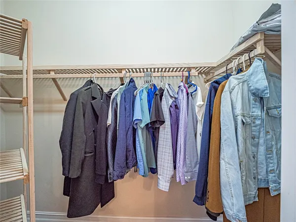 a view of walk in closet with clothes