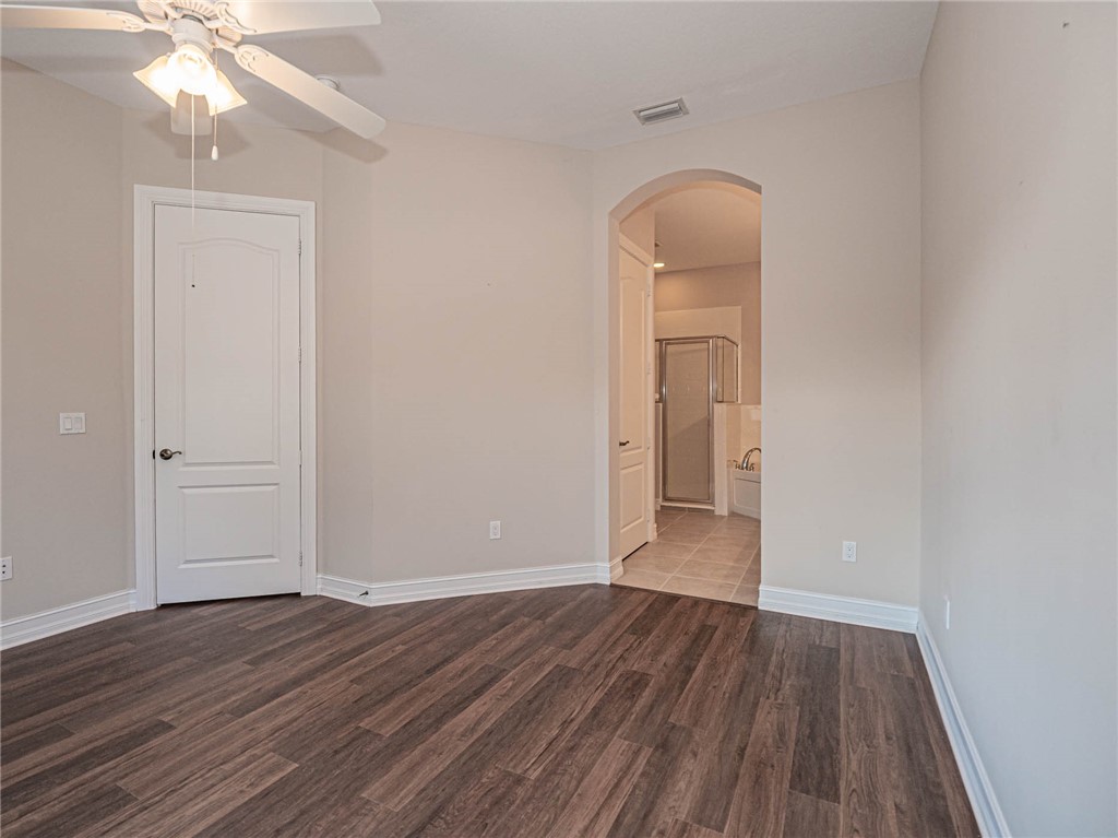 1875 Bridgepointe Circle, Unit 33 Vero Beach, FL 32967 - Photo 20 of 33 wooden floor in an empty room with a window
