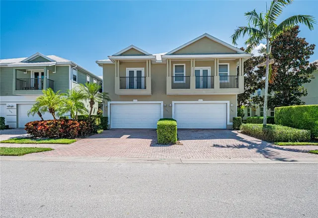 a front view of a house with a yard and outdoor seating
