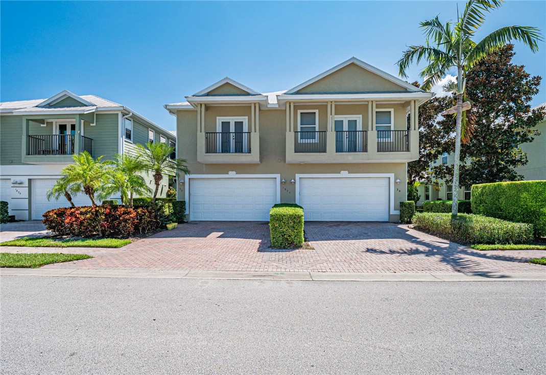 1875 Bridgepointe Circle, Unit 33 Vero Beach, FL 32967 - Photo 2 of 33 a front view of a house with a yard and outdoor seating