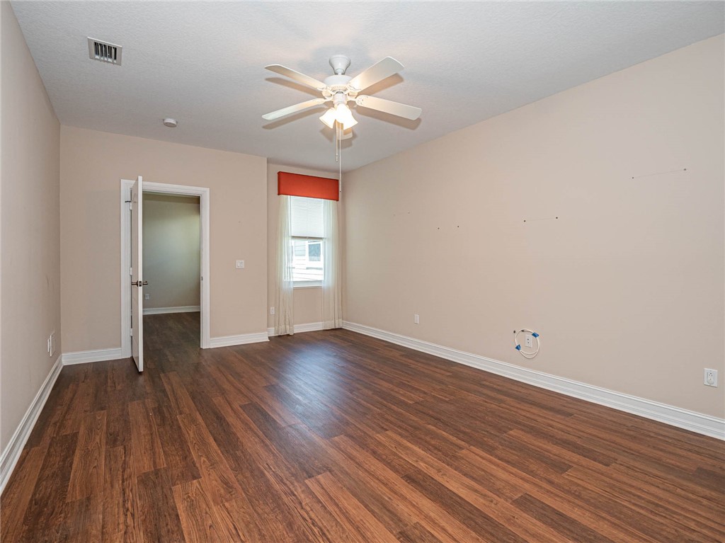 1875 Bridgepointe Circle, Unit 33 Vero Beach, FL 32967 - Photo 26 of 33 wooden floor in an empty room with a window