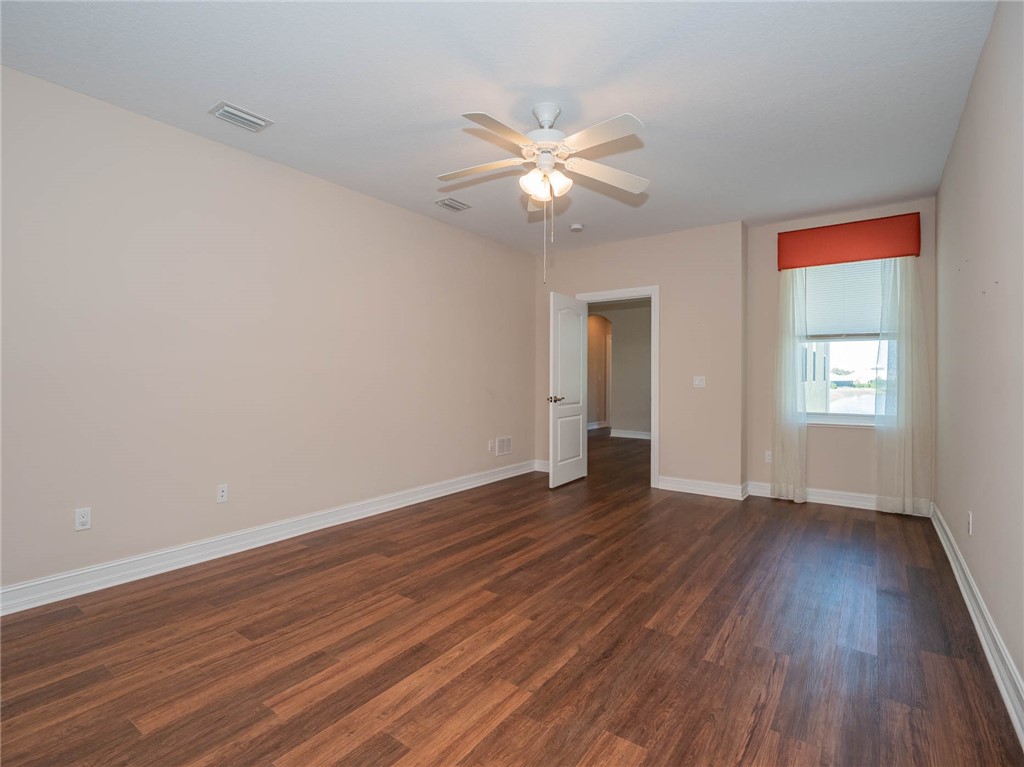 1875 Bridgepointe Circle, Unit 33 Vero Beach, FL 32967 - Photo 27 of 33 a view of an empty room with wooden floor and a window