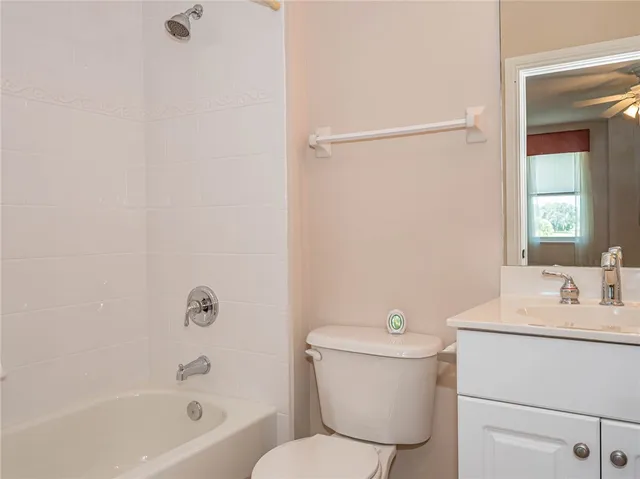 a white toilet sitting next to a bath tub