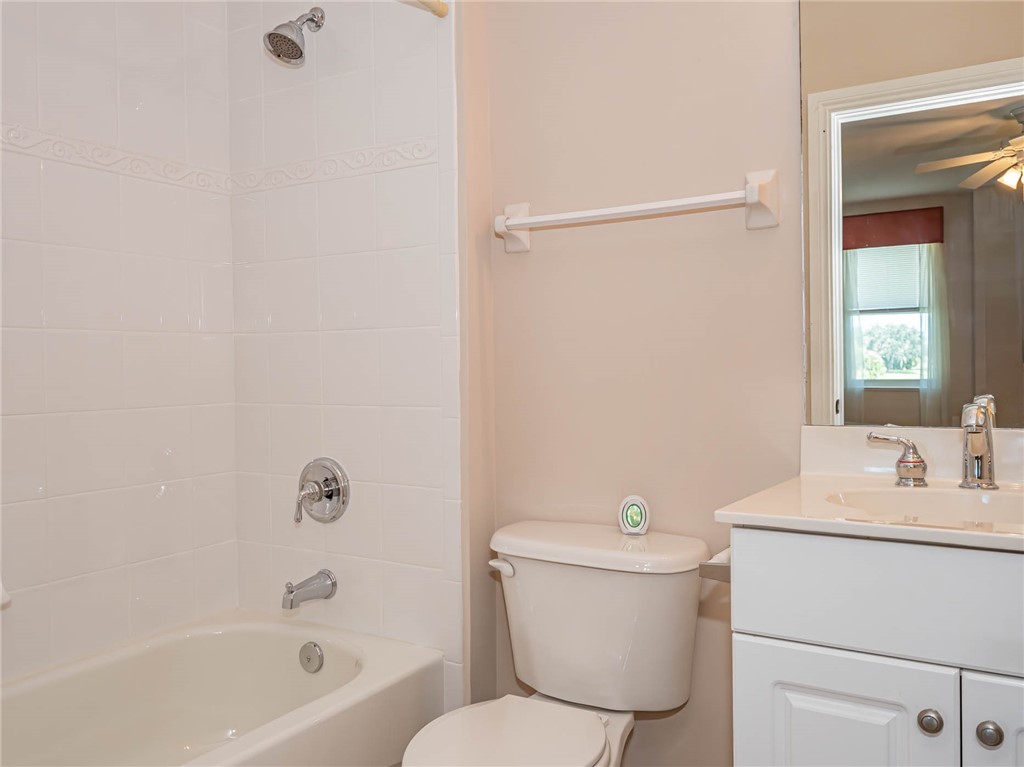 1875 Bridgepointe Circle, Unit 33 Vero Beach, FL 32967 - Photo 28 of 33 a white toilet sitting next to a bath tub
