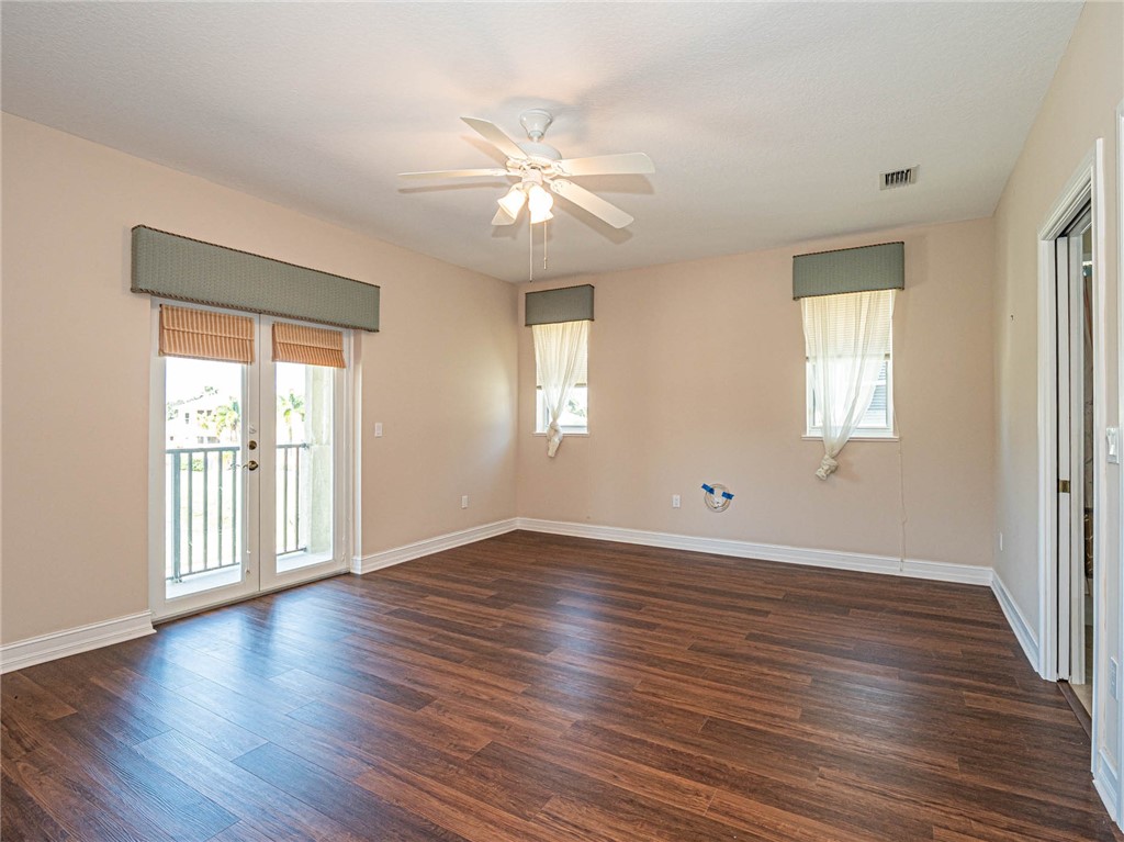 1875 Bridgepointe Circle, Unit 33 Vero Beach, FL 32967 - Photo 30 of 33 an empty room with wooden floor and windows