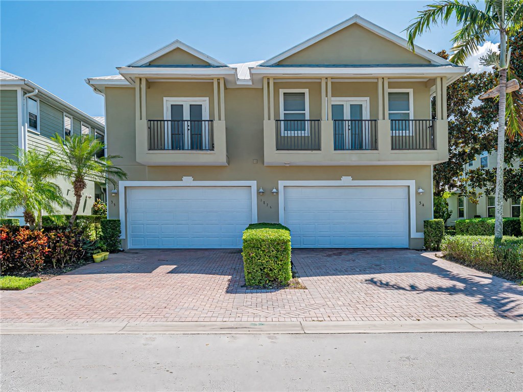 1875 Bridgepointe Circle, Unit 33 Vero Beach, FL 32967 - Photo 3 of 33 a front view of a house with a yard and garage