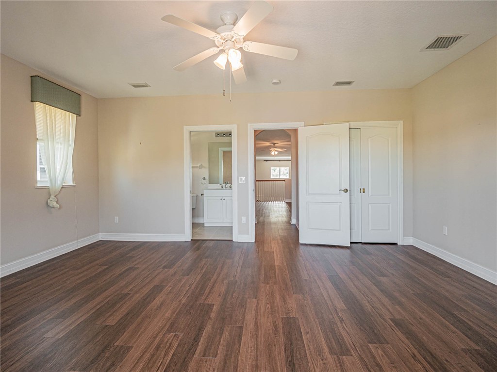 1875 Bridgepointe Circle, Unit 33 Vero Beach, FL 32967 - Photo 31 of 33 wooden floor in an empty room with a window