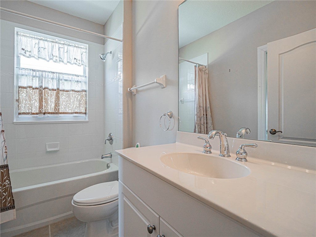 1875 Bridgepointe Circle, Unit 33 Vero Beach, FL 32967 - Photo 32 of 33 a bathroom with a sink toilet tub and shower