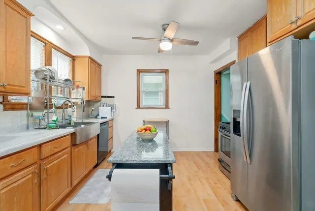 a kitchen with stainless steel appliances a refrigerator and a stove top oven